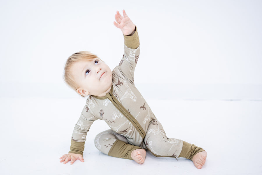 Baby boy in Eclipse Kids VelociNAPtor Zippy waving at the sky.