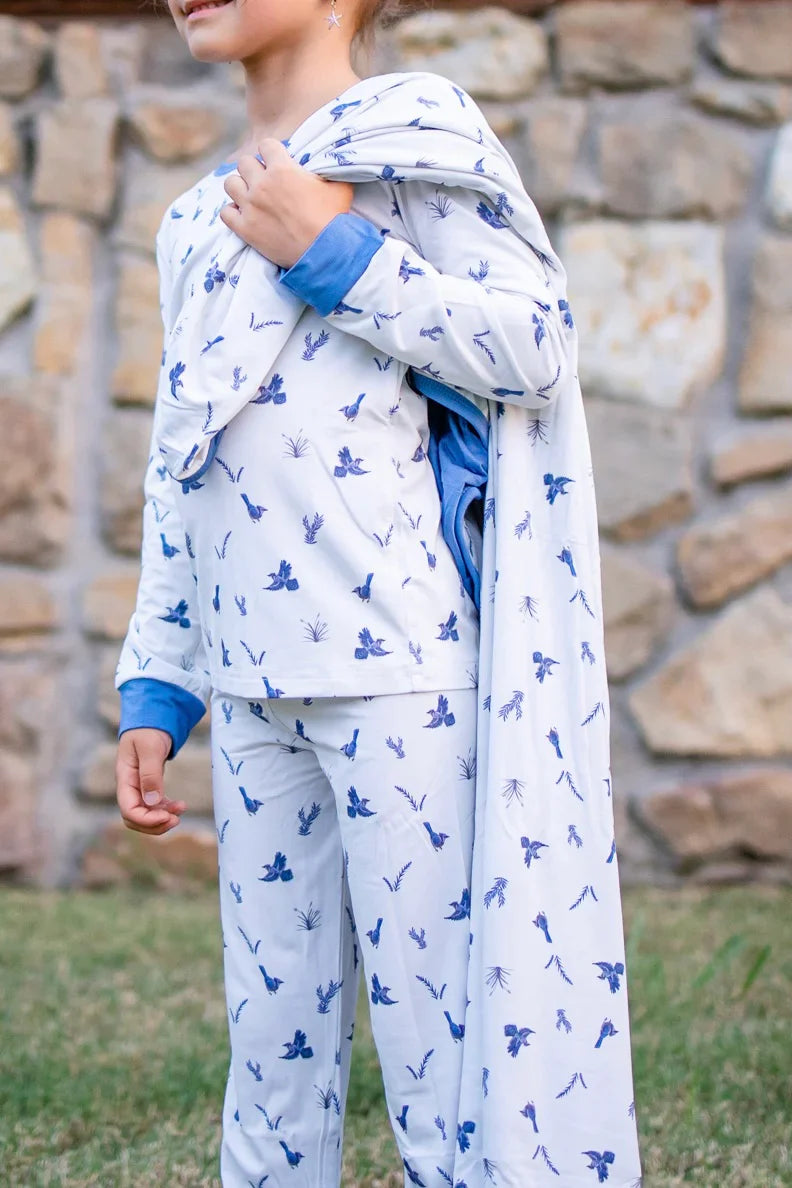 Young girl wearing the Blue Jays two piece set and holding a matching Luna Wrap over her should.